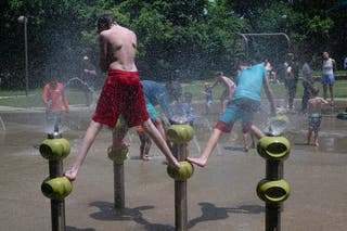 Children in Louisville, Kentucky, are played in park watercourses. The heat index values were forecast to exceed 100 degrees